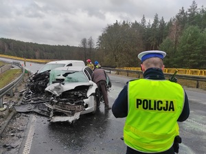 policjant wykonuje oględziny wypadku drogowego